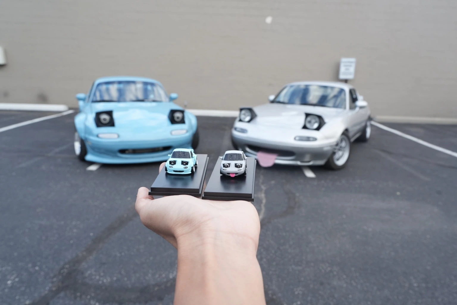 Both real Miatas with their matching blue and silver Chubbi models