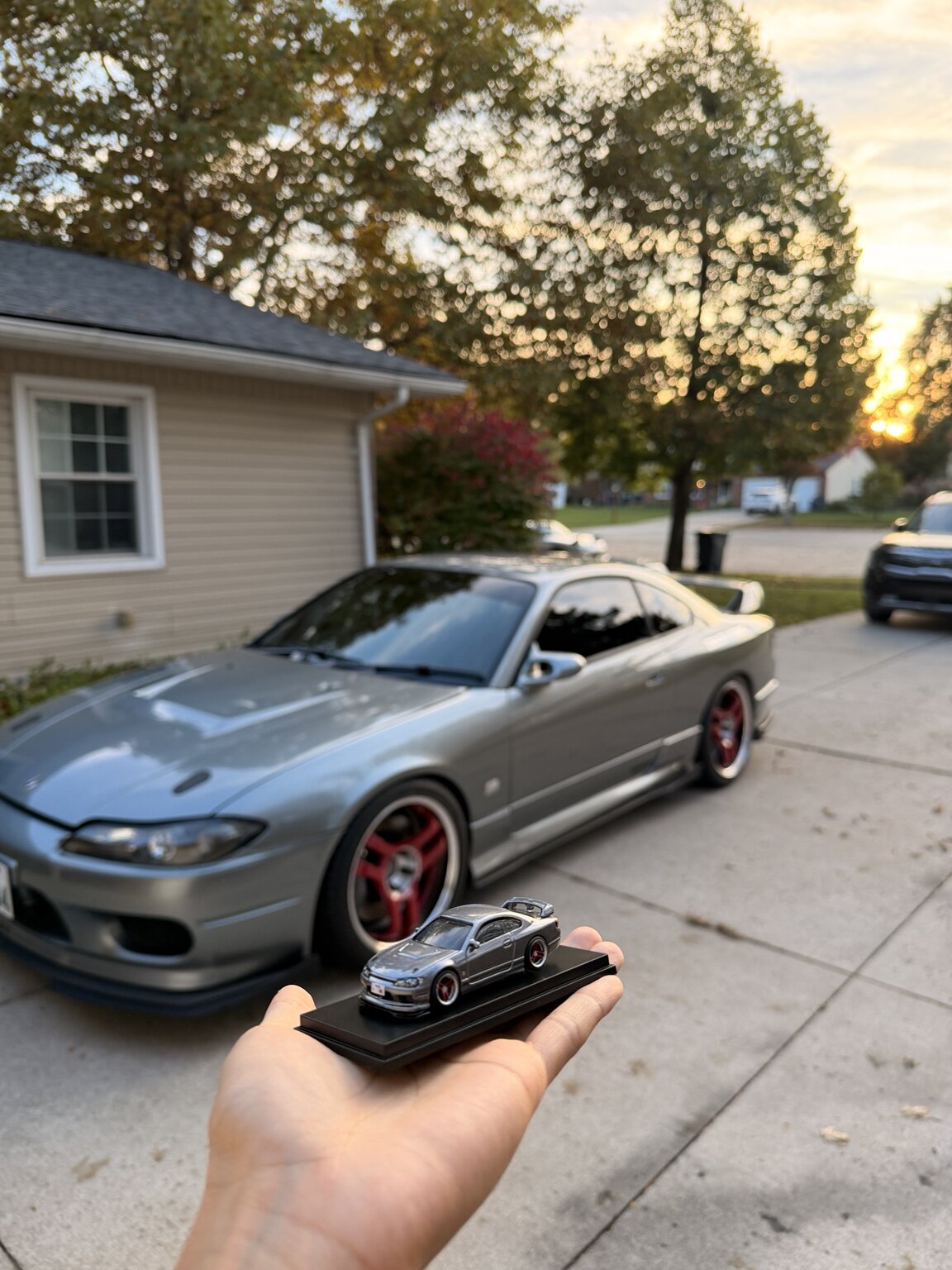 Hand-built S15 miniature held in front of Dennis’s matching silver Nissan Silvia