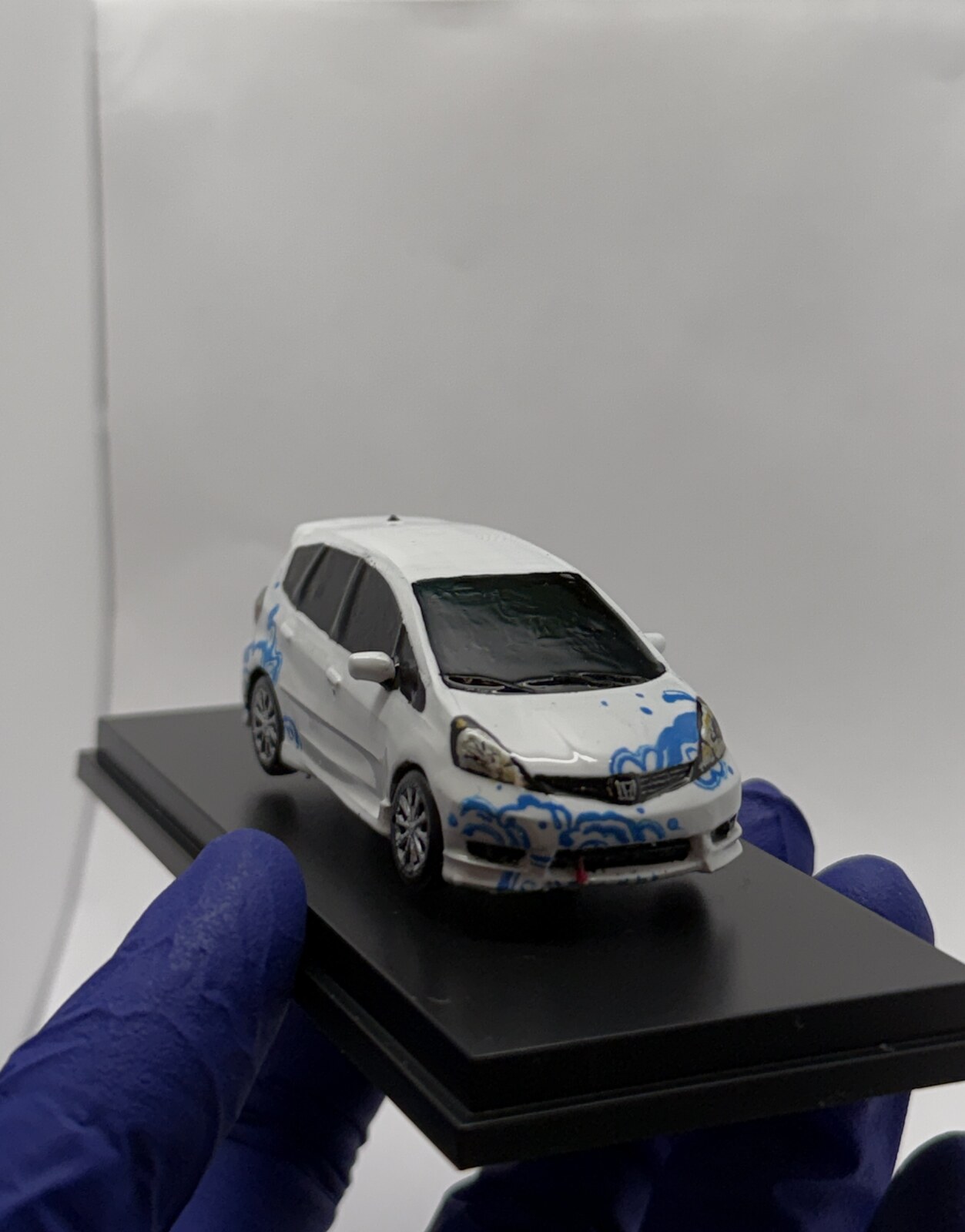 Front detail of the miniature showing hand-painted blue wave design