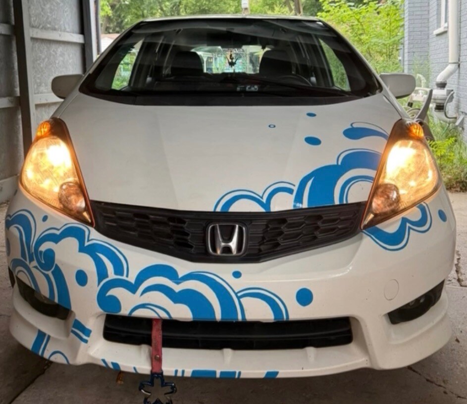Front detail of the real Honda Fit showing the blue wave design