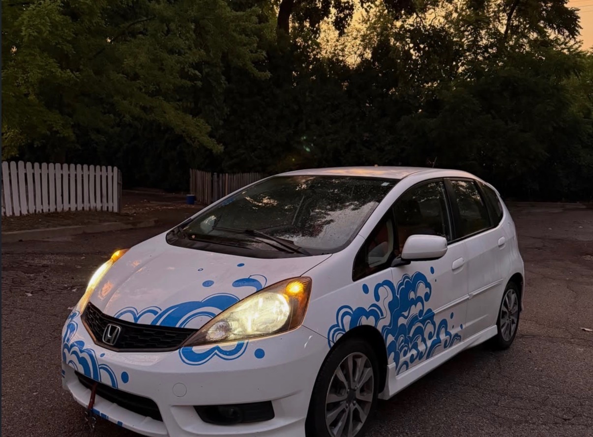 Real Honda Fit, front three-quarter view with blue wave artwork