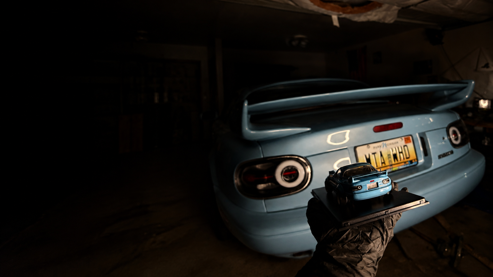 Matching full-size and miniature Project Blue Snow Miatas in the BP-ZE studio